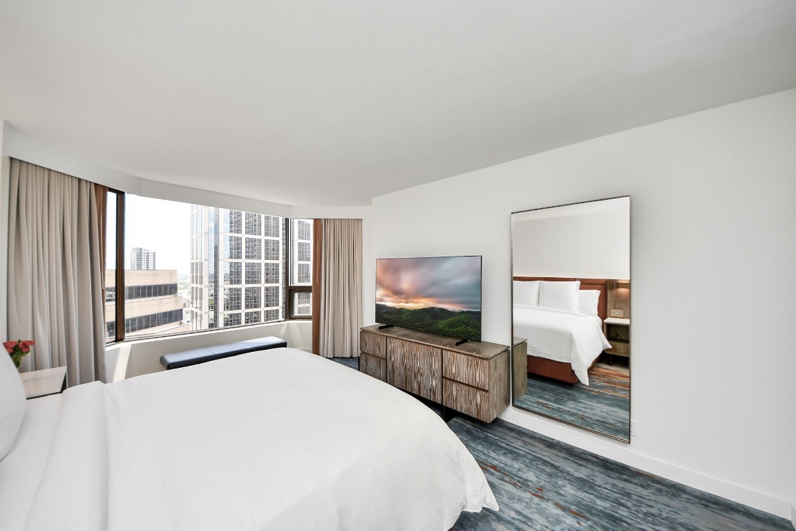 1300 Lamar Street, Unit T3 Houston, TX 77010 - Photo 23 of 49 a bedroom with a large bed and a large window