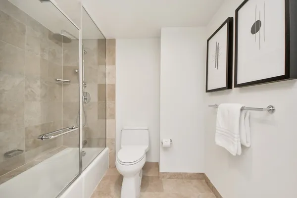 a bathroom with a toilet and a shower