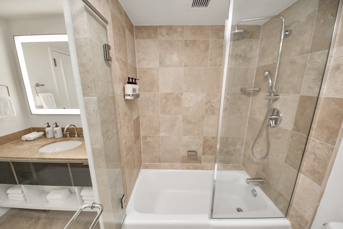 1300 Lamar Street, Unit T3 Houston, TX 77010 - Photo 32 of 49 a bathroom with a tub shower vanity and a sink