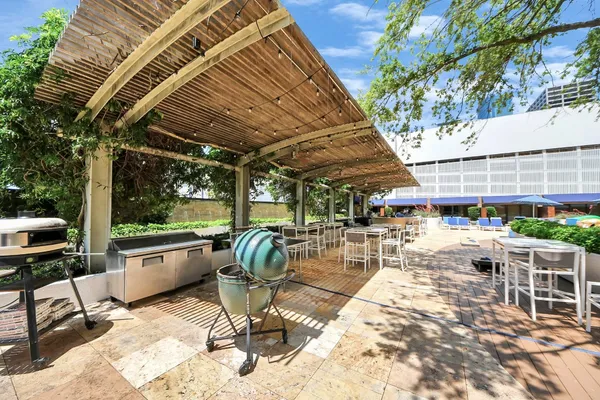 a view of a patio with a table and chairs and potted plants