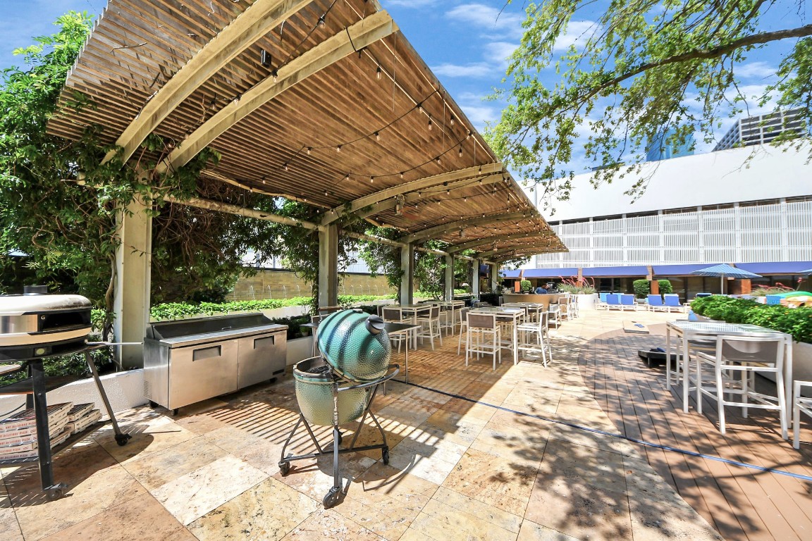 1300 Lamar Street, Unit T3 Houston, TX 77010 - Photo 42 of 49 a view of a patio with a table and chairs and potted plants