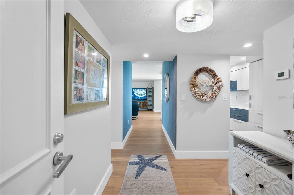 1050 Longboat Club Road, Unit 901 Longboat Key, FL 34228 - Photo 2 of 37 a view of a hallway to a livingroom with furniture