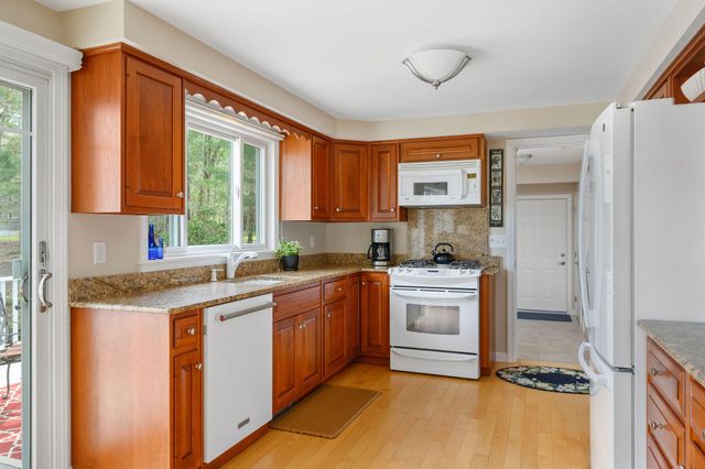 a kitchen with a sink cabinets and window