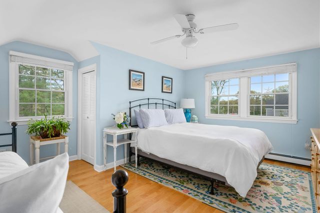 a bed sitting in a bedroom next to a window