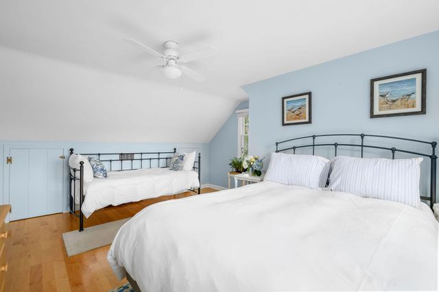 a bedroom with a bed and a night stand