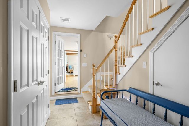 a view of an entryway with wooden floor and door