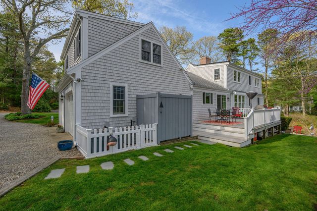 a front view of a house with a garden and deck