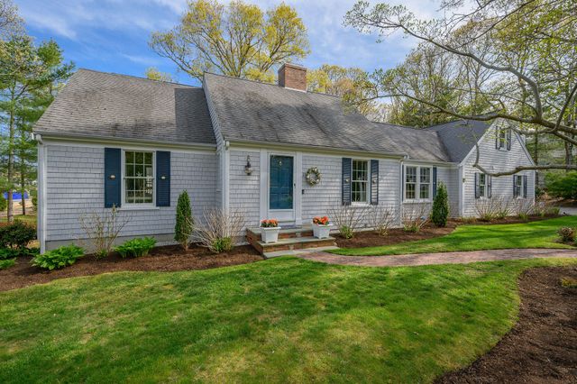 a backyard of a house with garden and barbeque oven