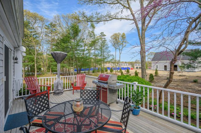 a view of a chairs and table in patio with a small yard