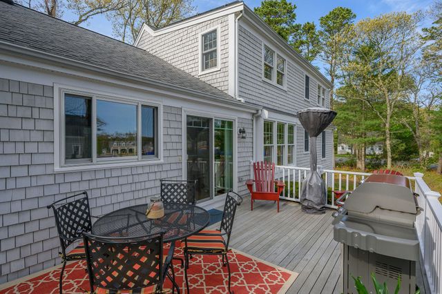 a view of a patio with table and chairs and wooden floor