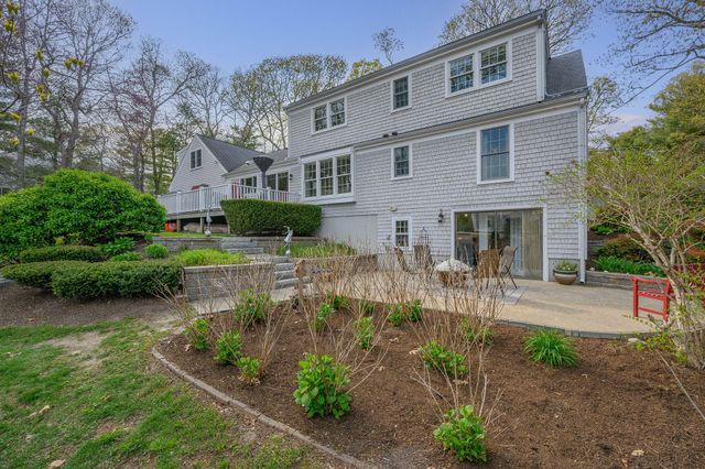 a front view of house with yard and outdoor seating