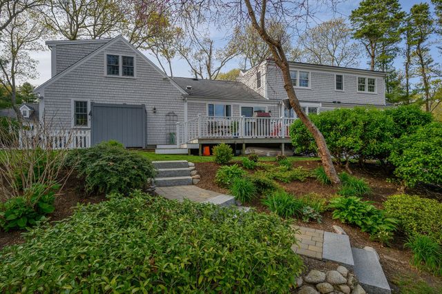 a front view of a house with yard and green space