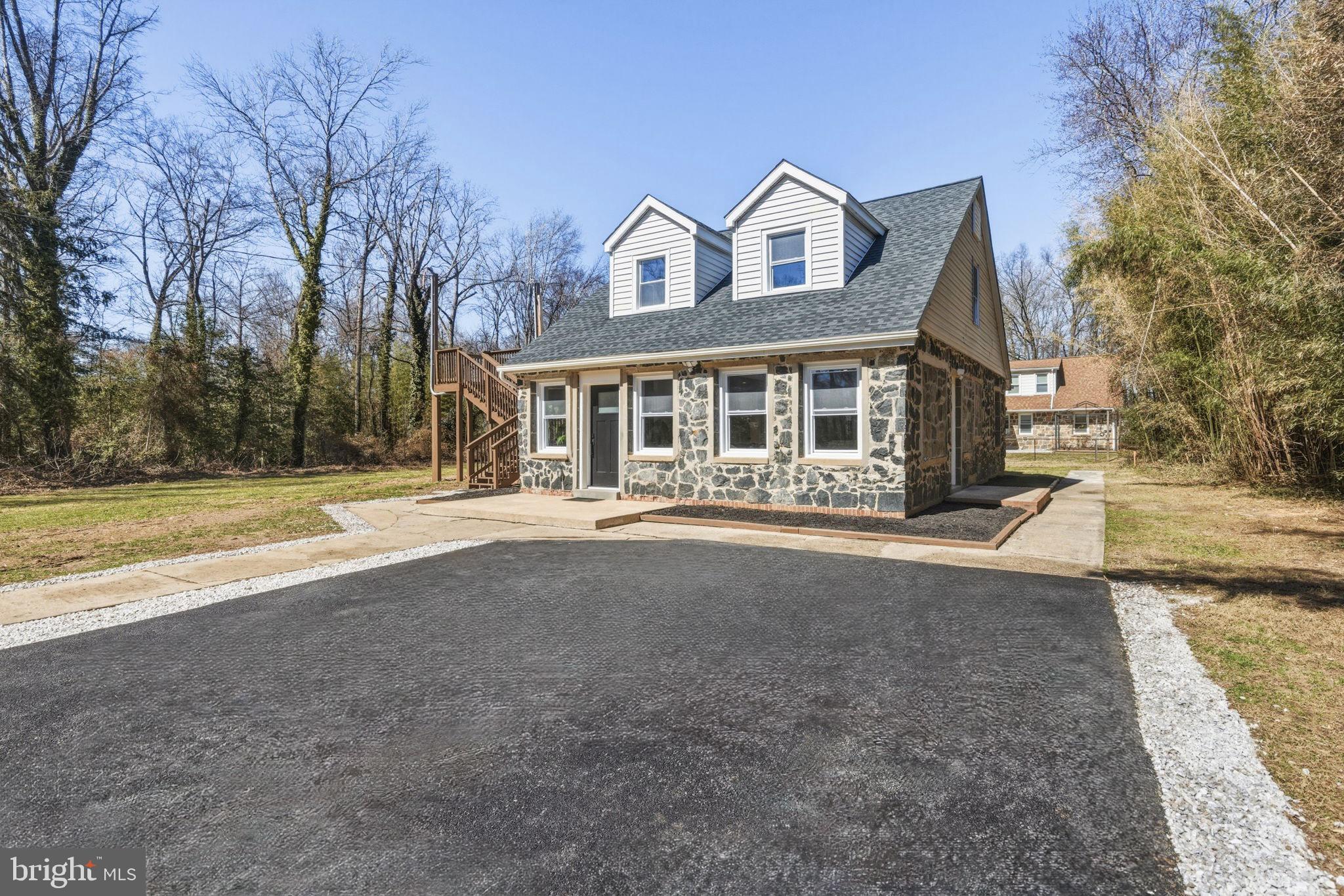 3236 George Street Baltimore, MD 21220 - Photo 2 of 32 a front view of a house with a garden and trees