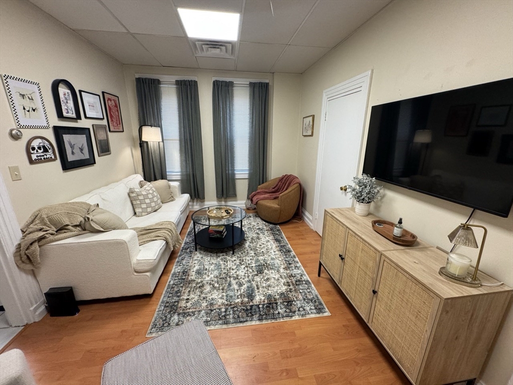 2 Champney Street, Unit 1 Boston, MA 02135 - Photo 2 of 9 a living room with furniture and a flat screen tv