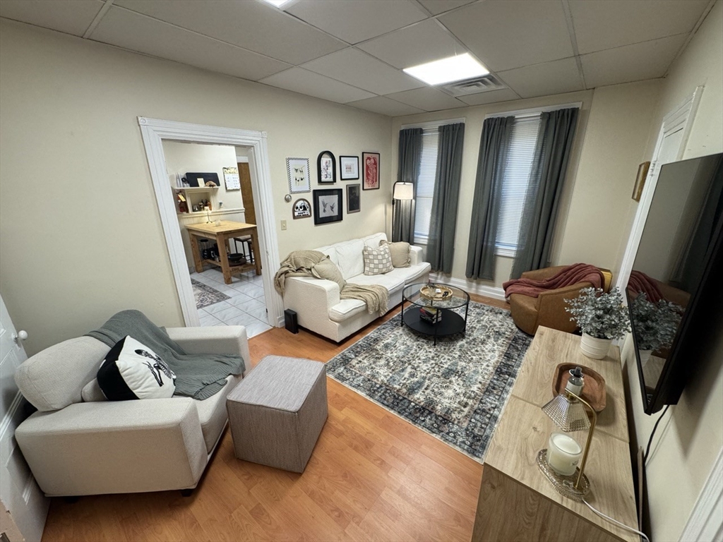 2 Champney Street, Unit 1 Boston, MA 02135 - Photo 4 of 9 a living room with furniture and a flat screen tv