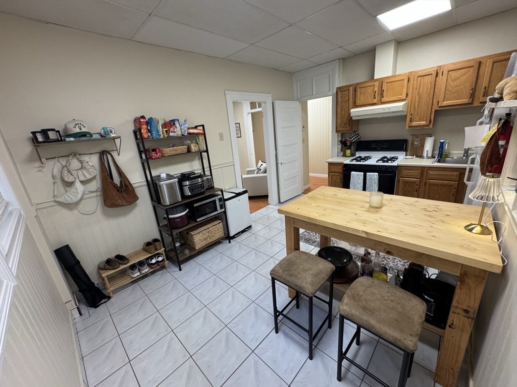 2 Champney Street, Unit 1 Boston, MA 02135 - Photo 7 of 9 a living room with furniture and a flat screen tv