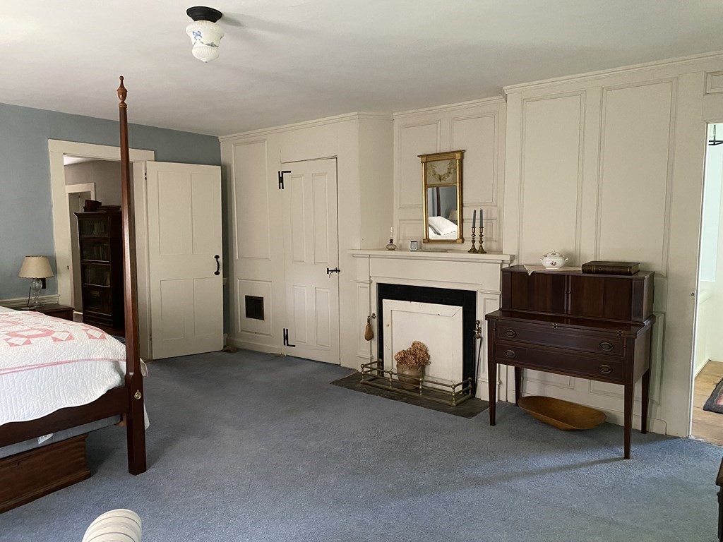 100 Brattleboro Road Bernardston, MA 01337 - Photo 20 of 42 a bedroom with a bed and a fireplace