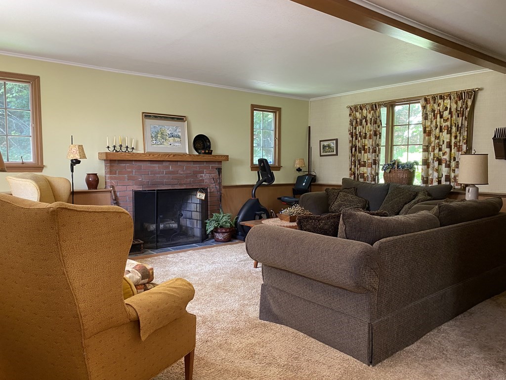 100 Brattleboro Road Bernardston, MA 01337 - Photo 29 of 42 a living room with furniture a large window and a fireplace