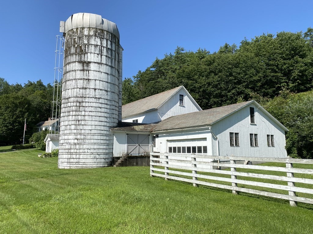 100 Brattleboro Road Bernardston, MA 01337 - Photo 5 of 42 a view of a white house with a big yard and large trees