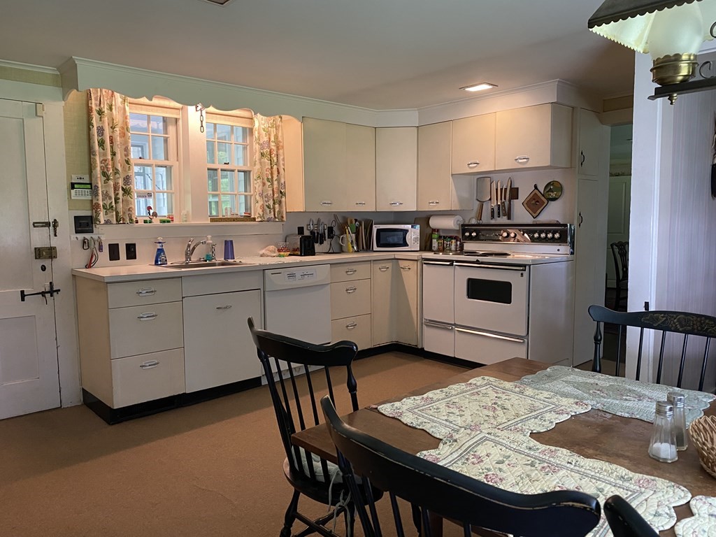 100 Brattleboro Road Bernardston, MA 01337 - Photo 7 of 42 a kitchen with stainless steel appliances kitchen island granite countertop a sink a stove a refrigerator and cabinets