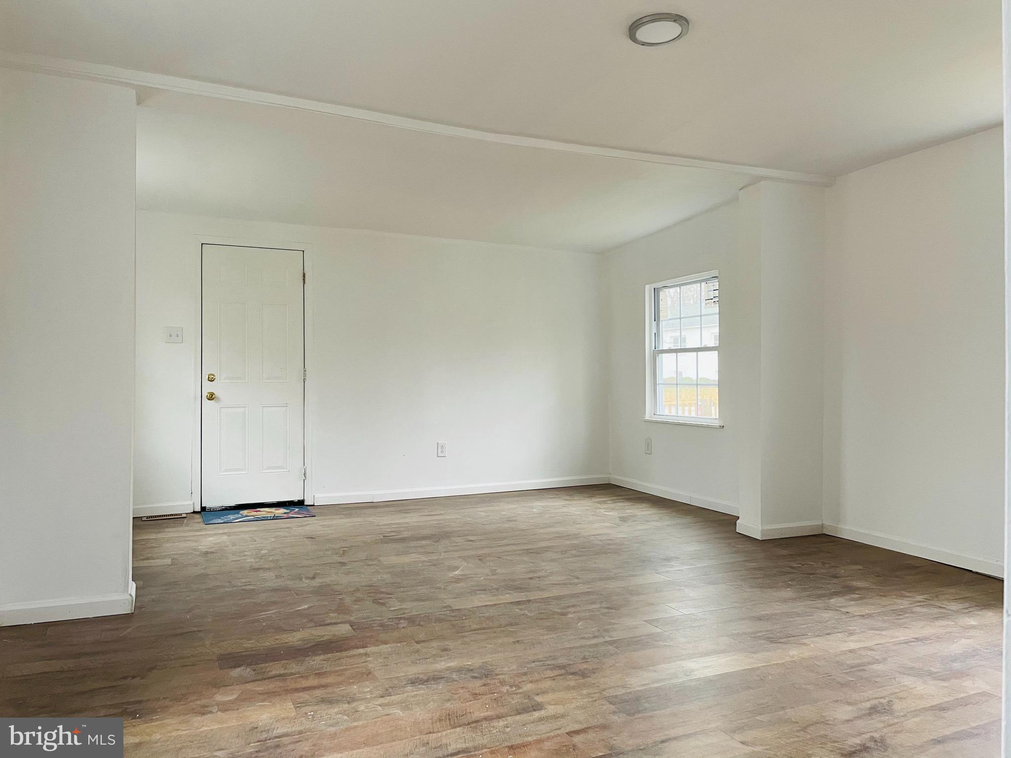 301 Erial Road Pine Hill, NJ 08021 - Photo 8 of 8 an empty room with wooden floor and windows
