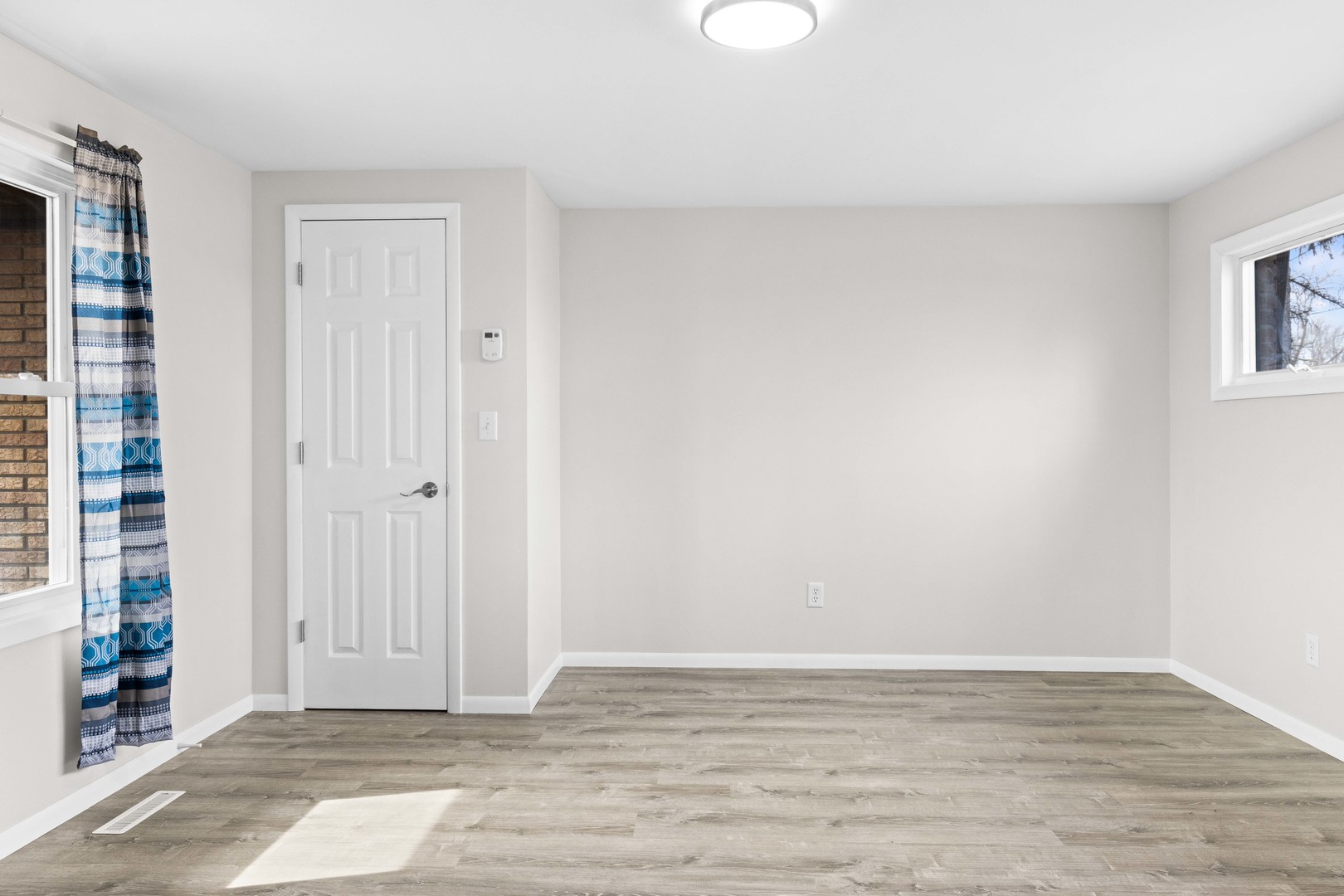 1579 West 2000S Road Kankakee, IL 60901 - Photo 13 of 24 a view of an empty room with window and wooden floor