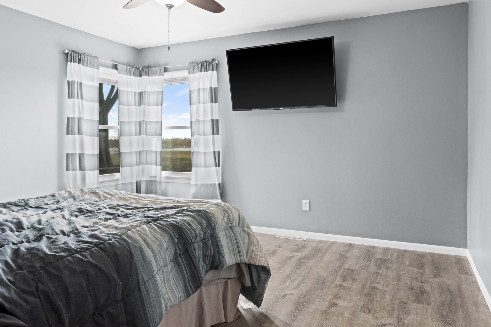1579 West 2000S Road Kankakee, IL 60901 - Photo 15 of 24 a bedroom with a bed and a flat screen tv