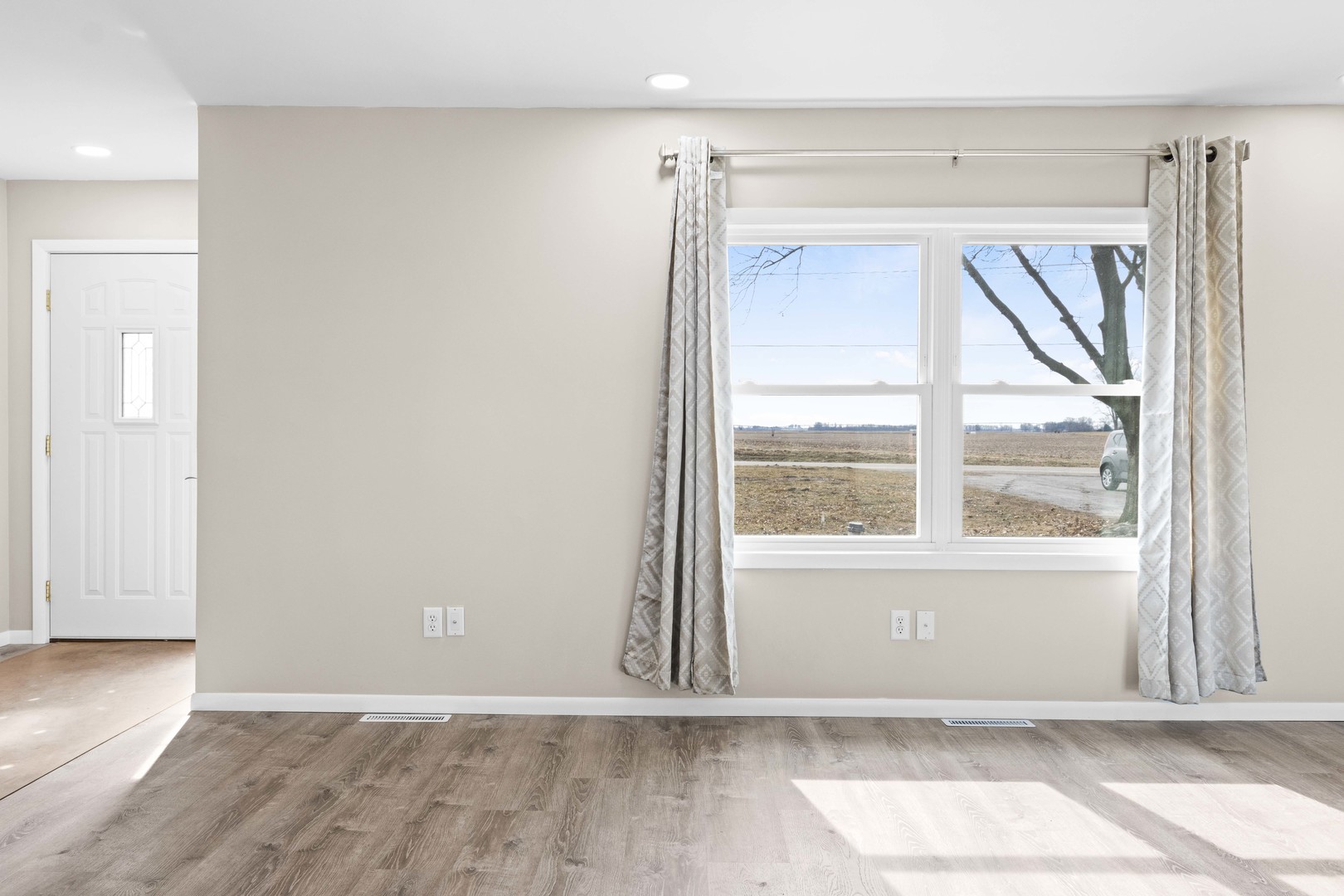 1579 West 2000S Road Kankakee, IL 60901 - Photo 21 of 24 an empty room with wooden floor and windows