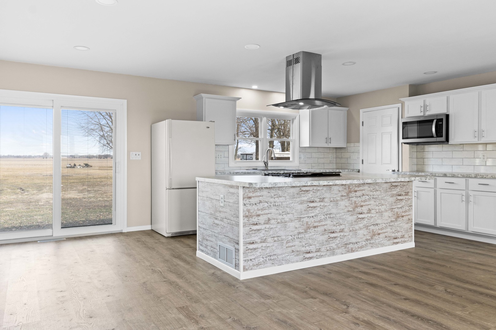 1579 West 2000S Road Kankakee, IL 60901 - Photo 5 of 24 a kitchen with kitchen island granite countertop a stove top oven a refrigerator a sink and a granite counter tops