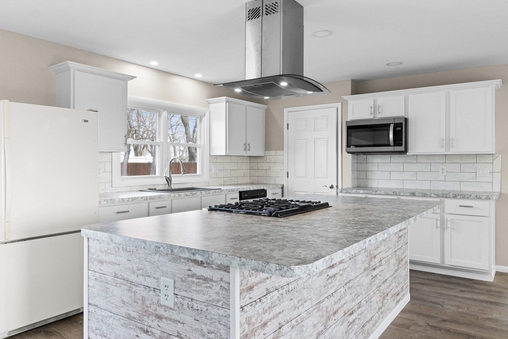 1579 West 2000S Road Kankakee, IL 60901 - Photo 7 of 24 a kitchen with stainless steel appliances granite countertop a sink a stove top oven a counter space and cabinets