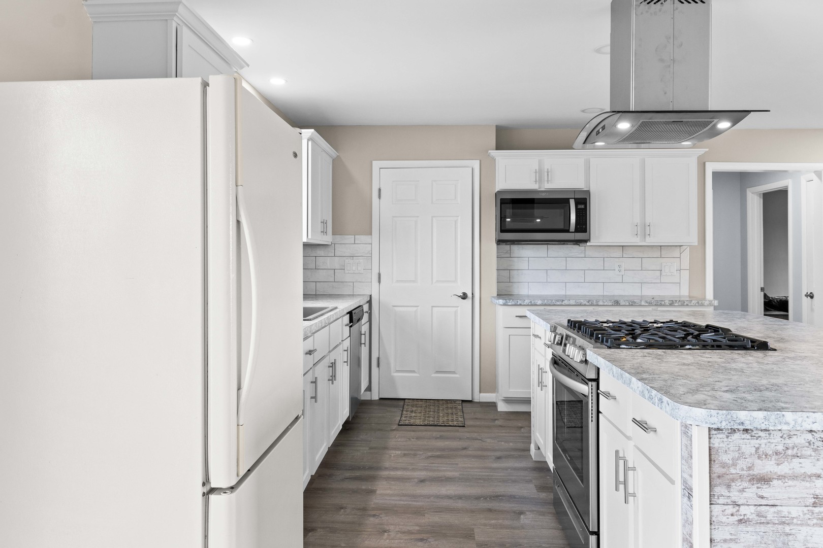 1579 West 2000S Road Kankakee, IL 60901 - Photo 9 of 24 a kitchen with stainless steel appliances granite countertop a stove and a refrigerator