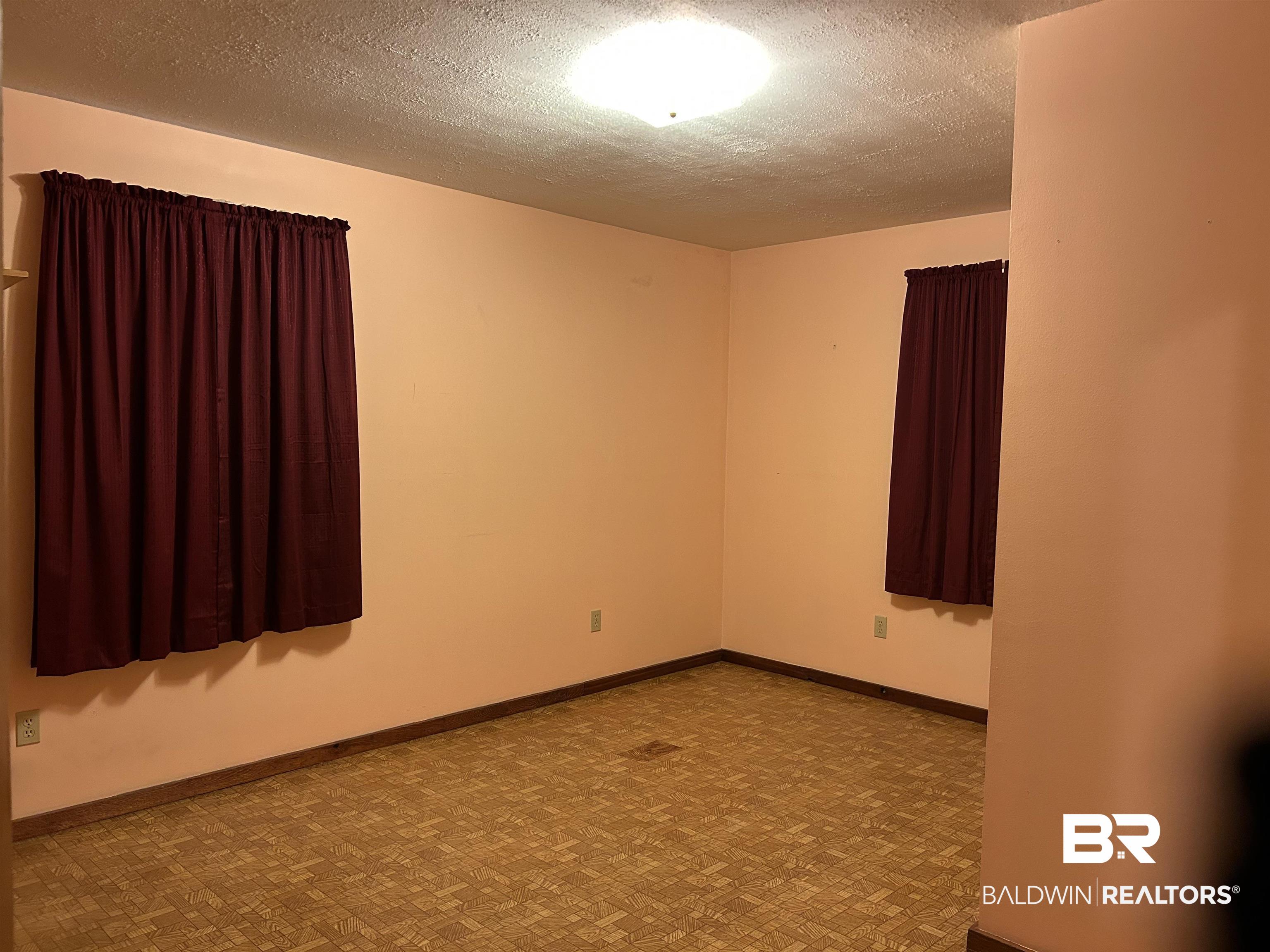 1350 A Schillinger Road South Mobile, AL 36695 - Photo 8 of 18 Unfurnished room featuring a textured ceiling and tile patterned floors