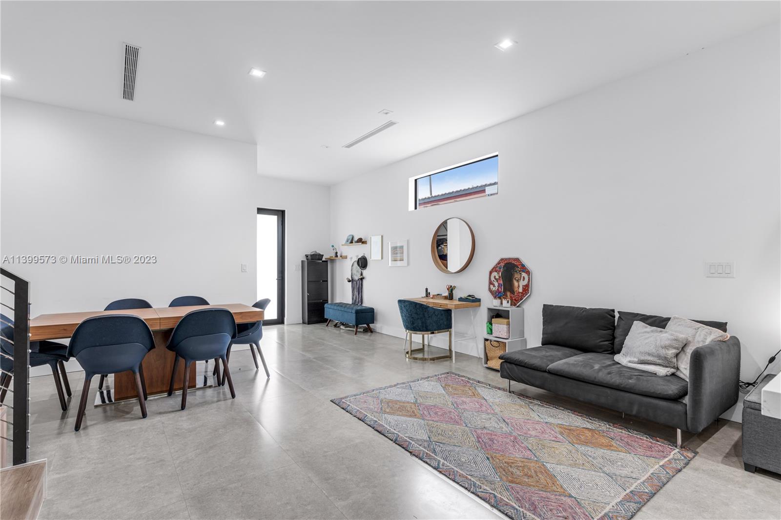 2936 Southwest 35th Avenue, Unit 2936 Miami, FL 33133 - Photo 4 of 22 a living room with furniture and a wall painting