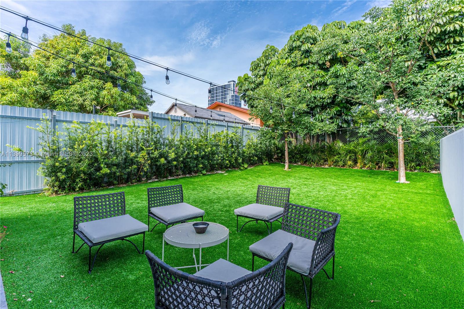 2936 Southwest 35th Avenue, Unit 2936 Miami, FL 33133 - Photo 5 of 22 a view of a chair and table in the garden