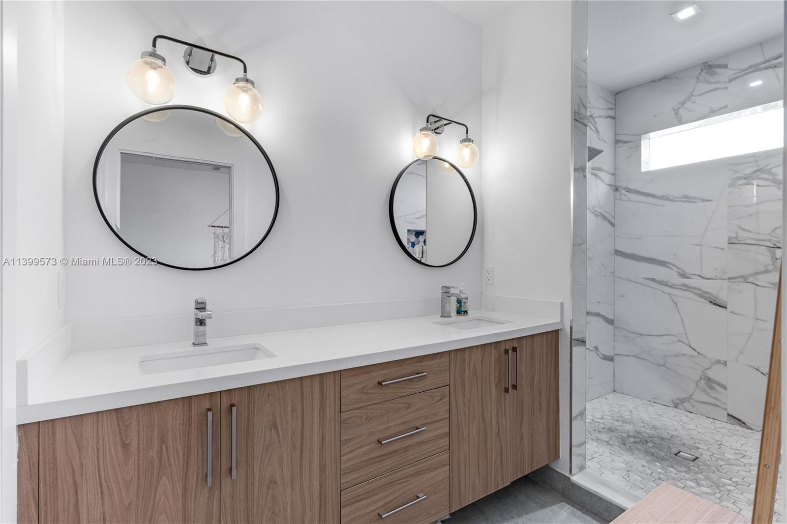 2936 Southwest 35th Avenue, Unit 2936 Miami, FL 33133 - Photo 8 of 22 a bathroom with a double vanity sink and a mirror