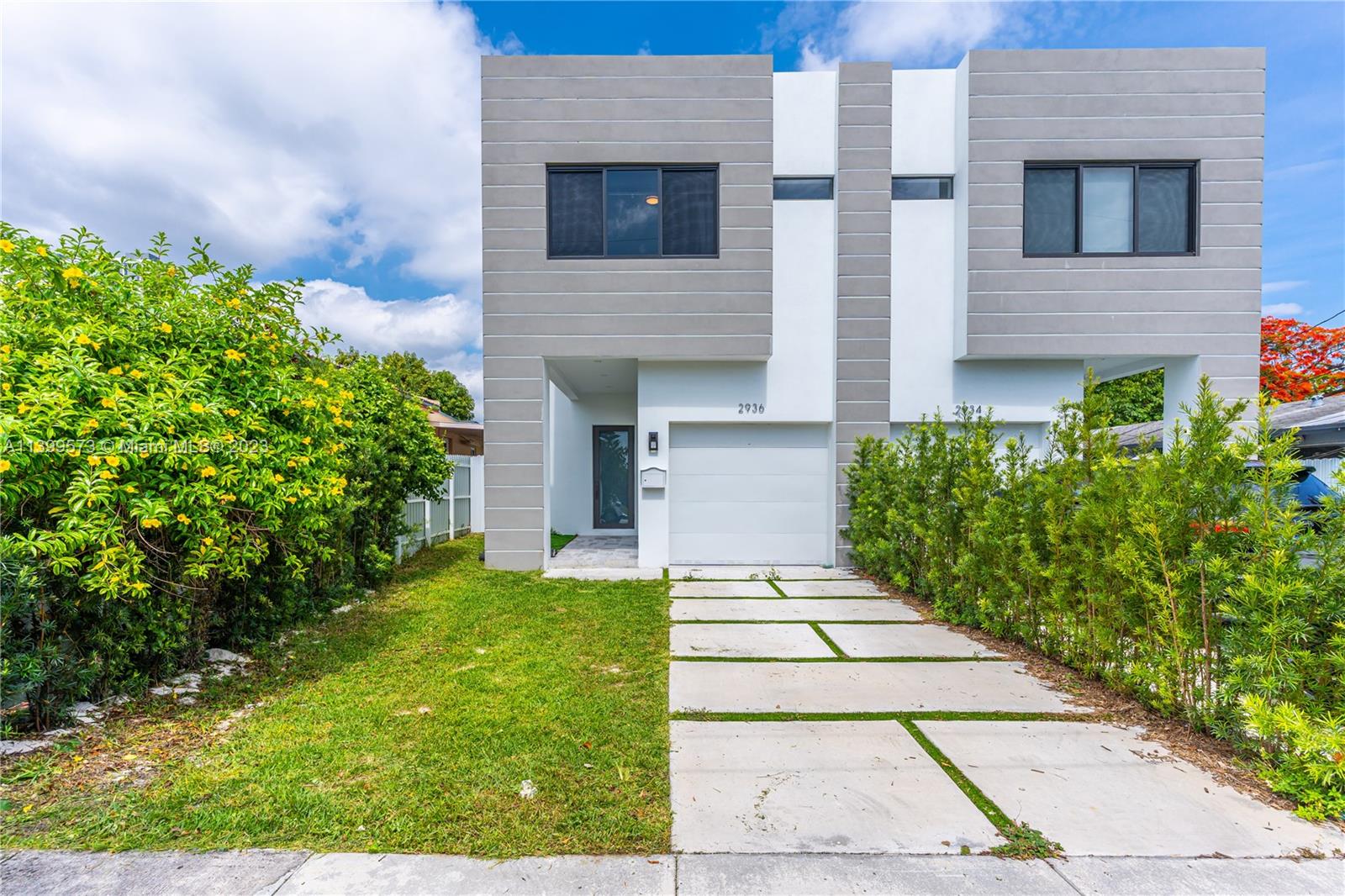 2936 Southwest 35th Avenue, Unit 2936 Miami, FL 33133 - Photo 9 of 22 a front view of a house with garden