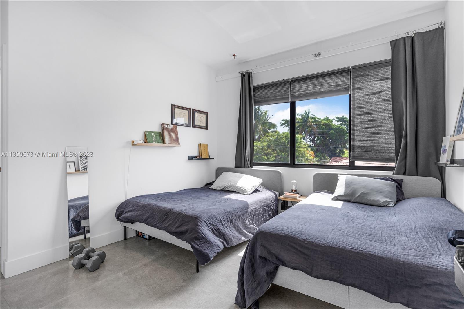 2936 Southwest 35th Avenue, Unit 2936 Miami, FL 33133 - Photo 10 of 22 a bedroom with two beds and a large window
