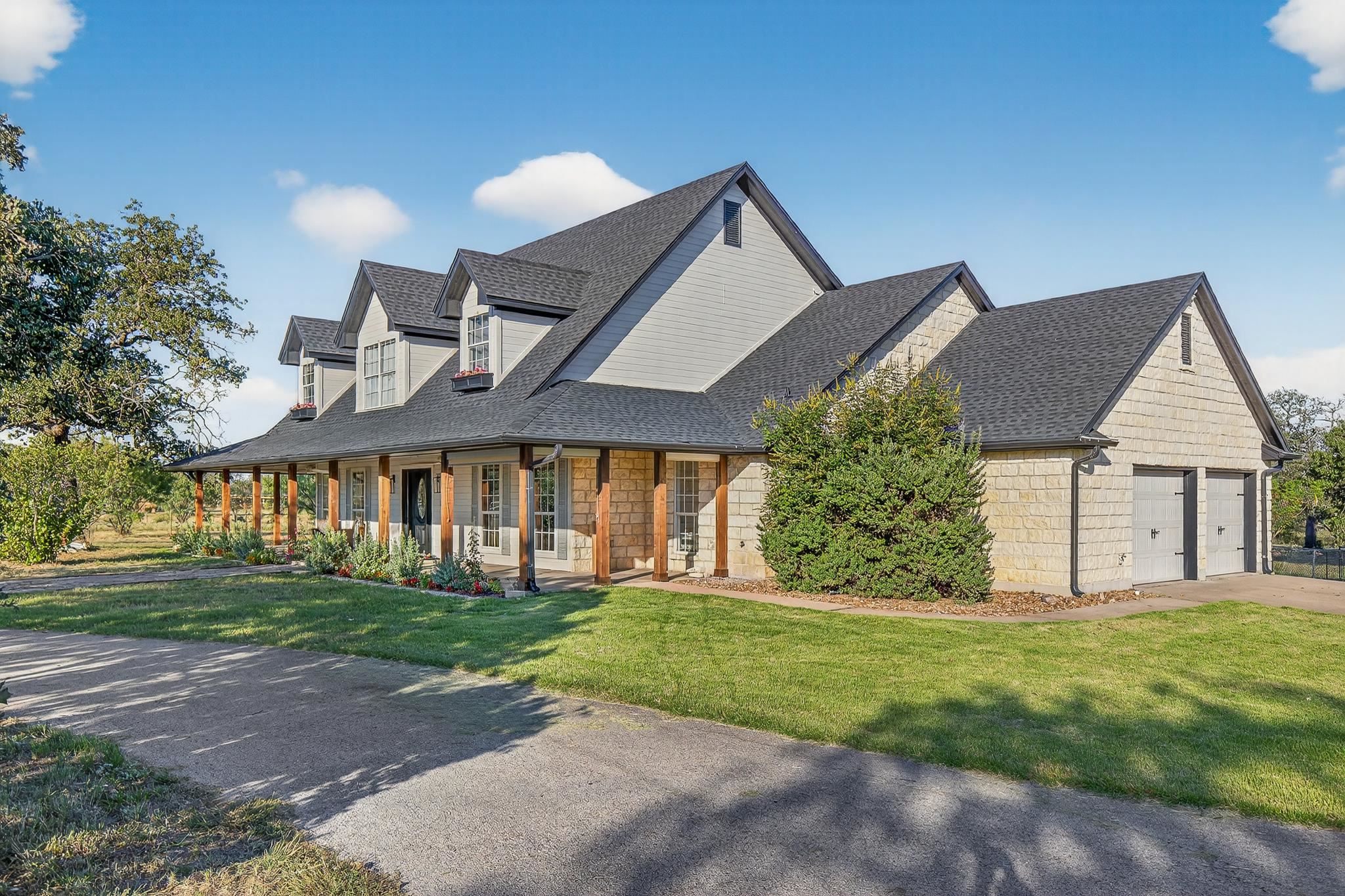 a front view of a house with a yard and garage
