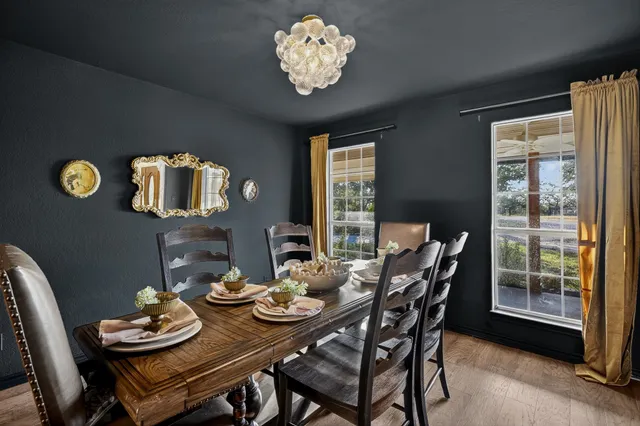 a view of a dining room with furniture and chandelier