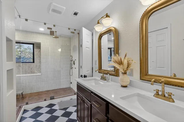 a spacious bathroom with a granite countertop sink and a mirror