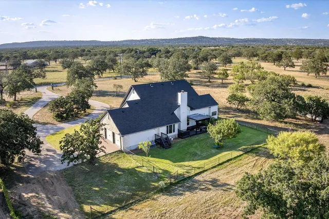 an aerial view of residential houses with outdoor space
