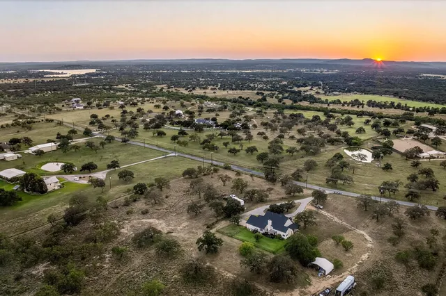 an aerial view of residential house and sandy dunes