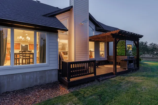 a view of a house with a yard and deck