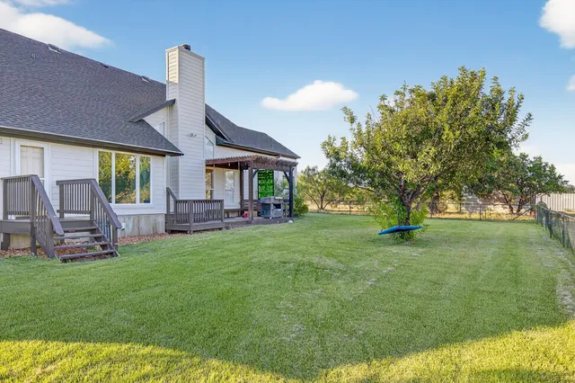 a view of a house with a backyard porch and sitting area