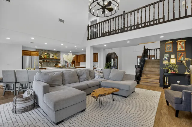 a living room with furniture or kitchen view and a wooden floor