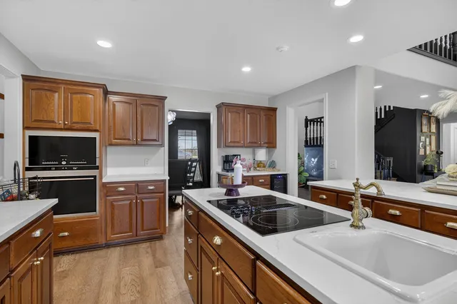 a kitchen with a sink stove top oven and refrigerator