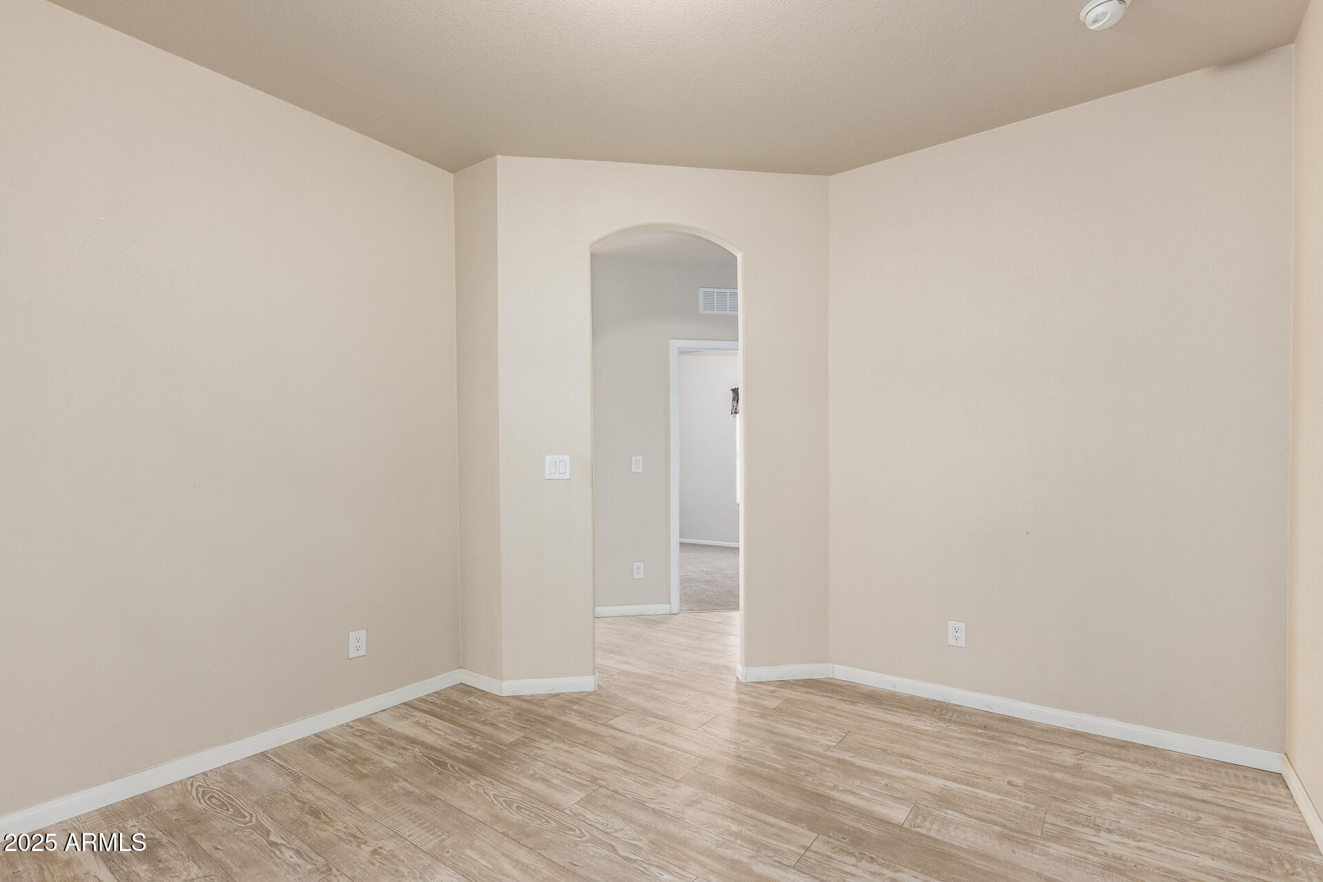 2929 East Main Street, Unit 217 Mesa, AZ 85213 - Photo 20 of 33 a view of an empty room with wooden floor and closet