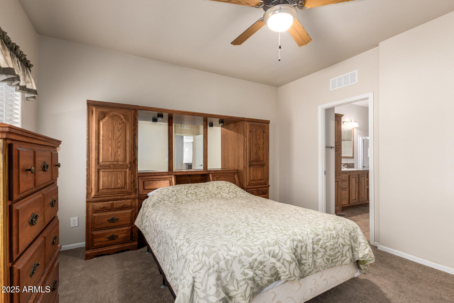 2929 East Main Street, Unit 217 Mesa, AZ 85213 - Photo 10 of 33 a bedroom with a bed and a chandelier