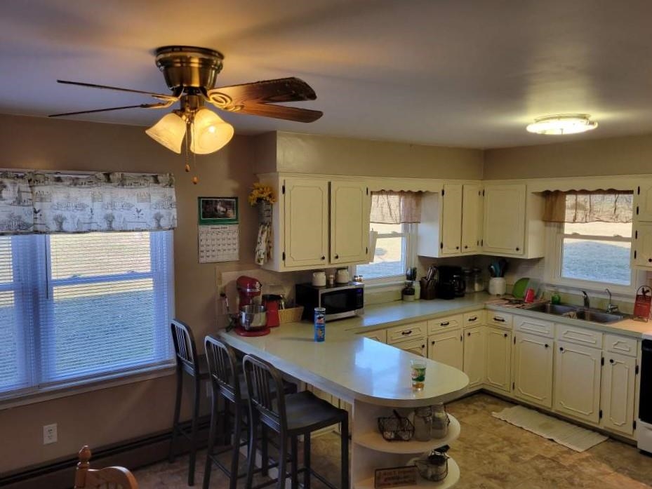 102 Fort Defiance Road Fort Defiance, VA 24437 - Photo 8 of 13 a kitchen with a table chairs stove and microwave