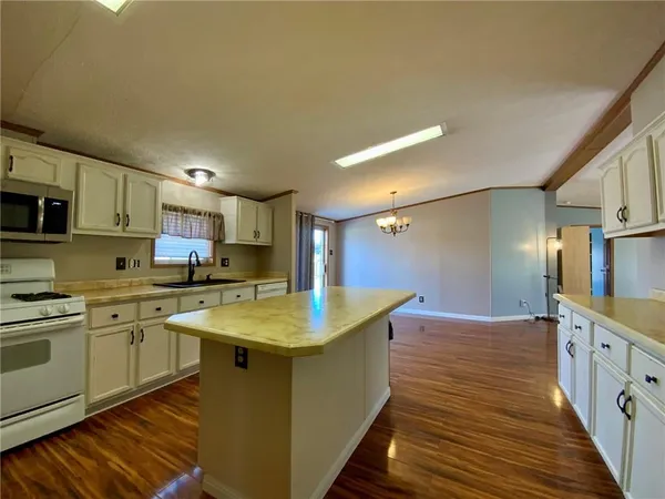 a kitchen with stainless steel appliances granite countertop a sink and cabinets